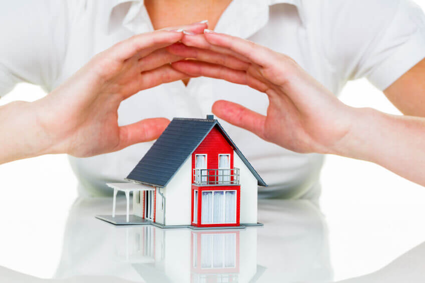 The person covering the small model house with hands at Hurst, TX